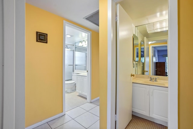 bathroom with tile patterned floors, vanity, and toilet