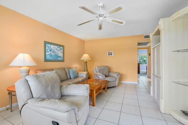 tiled living room featuring ceiling fan and a textured ceiling