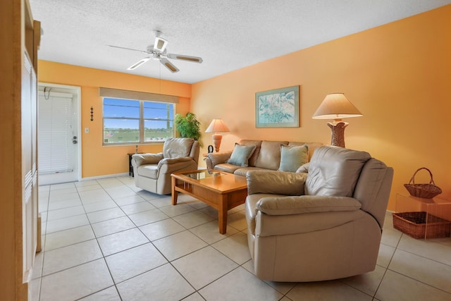 living room with light tile patterned floors, a textured ceiling, and ceiling fan