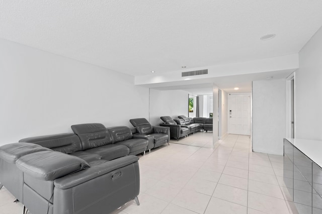 tiled living room featuring a textured ceiling