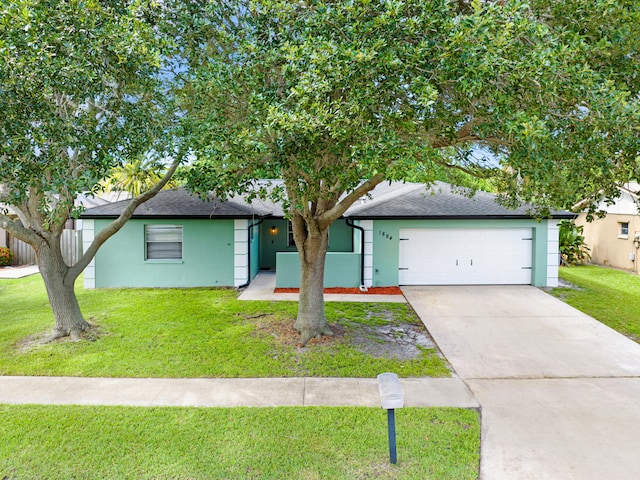 ranch-style house featuring a garage and a front yard