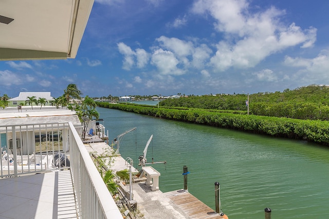 balcony with a boat dock and a water view