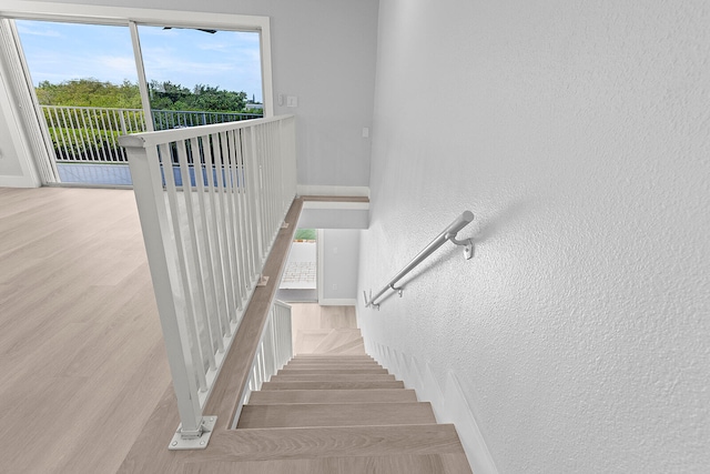 staircase with light hardwood / wood-style floors