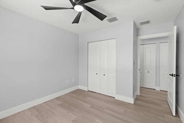 unfurnished bedroom featuring ceiling fan, a closet, and light hardwood / wood-style floors