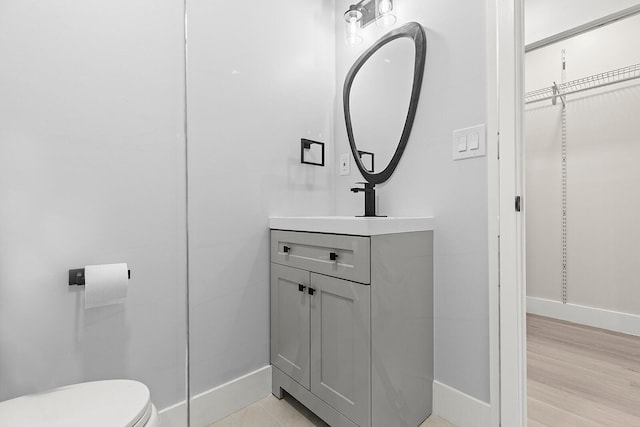 bathroom featuring hardwood / wood-style floors, toilet, and vanity