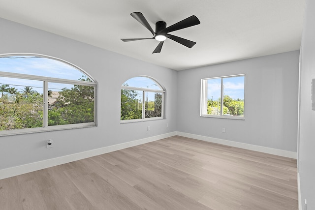 empty room featuring ceiling fan and light hardwood / wood-style flooring