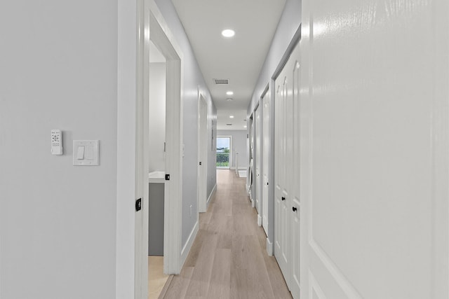 hall with light hardwood / wood-style floors