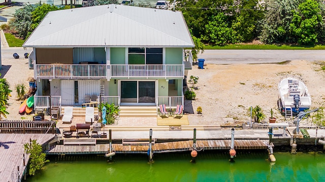 back of property with a balcony and a wooden deck