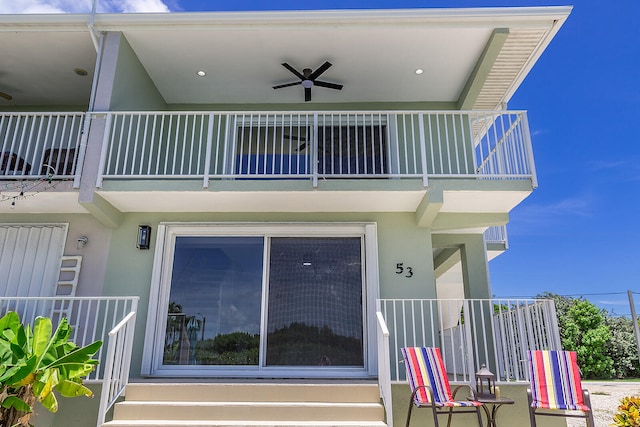 rear view of house with a balcony and ceiling fan