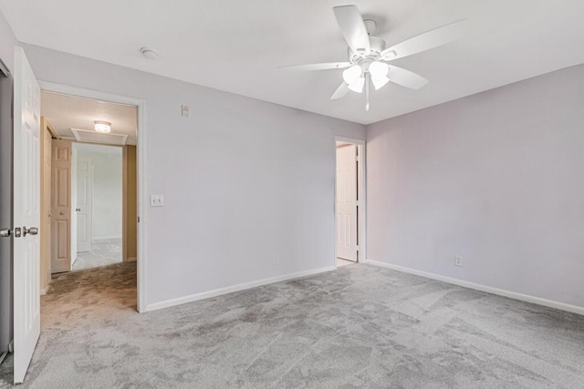 spare room featuring light colored carpet and ceiling fan