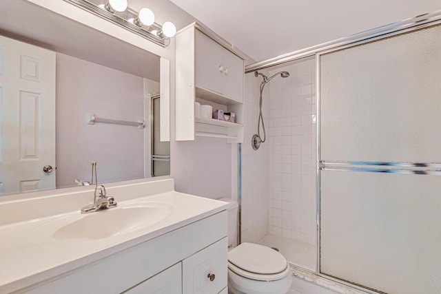 bathroom with vanity, toilet, and walk in shower