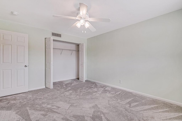 unfurnished bedroom featuring ceiling fan, a closet, and light carpet