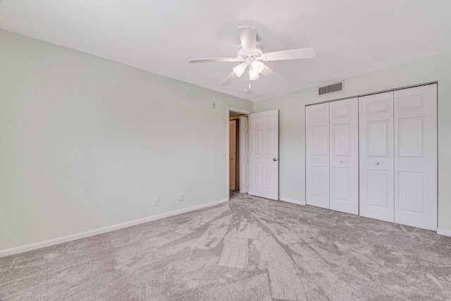 unfurnished bedroom with light carpet, a closet, and ceiling fan