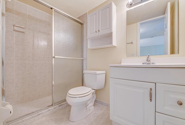 bathroom with tile patterned flooring, vanity, toilet, and a shower with door