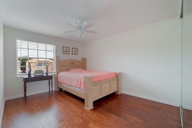 bedroom featuring dark wood-type flooring and ceiling fan