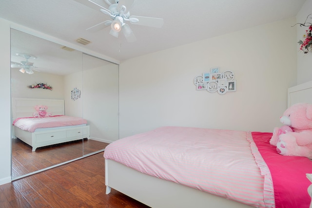 bedroom featuring dark hardwood / wood-style floors, a closet, and ceiling fan