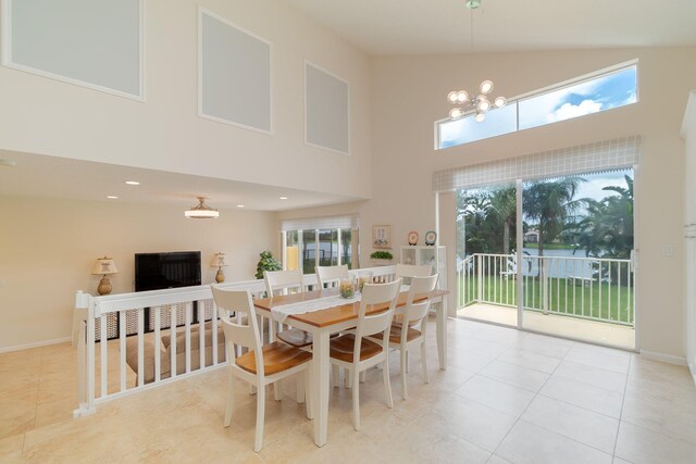 dining space with a notable chandelier, high vaulted ceiling, and light tile flooring