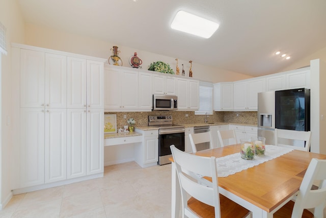 kitchen with stainless steel appliances, white cabinets, backsplash, and sink