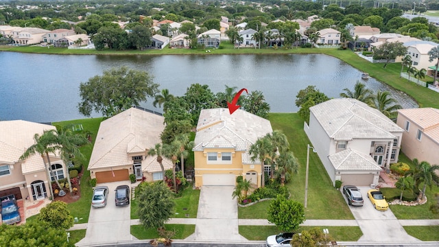 birds eye view of property with a water view