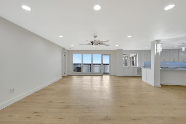 unfurnished living room with light hardwood / wood-style floors and ceiling fan