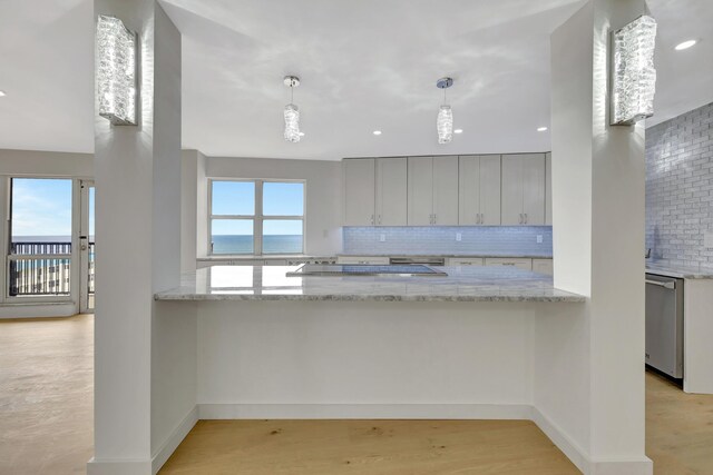 kitchen featuring light hardwood / wood-style flooring, dishwasher, tasteful backsplash, and gray cabinetry