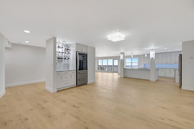 kitchen featuring light hardwood / wood-style floors, stainless steel fridge, and gray cabinetry