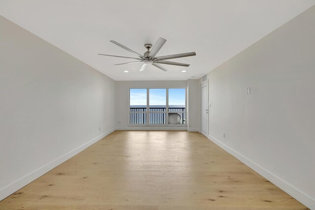 empty room with light hardwood / wood-style floors and ceiling fan