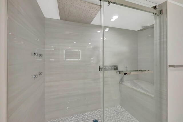 bathroom featuring a shower with shower door