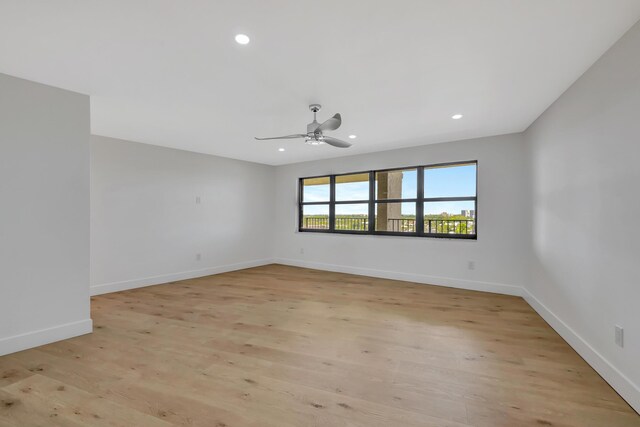 spare room featuring light wood-type flooring and ceiling fan