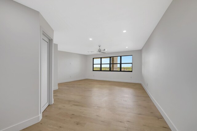 empty room featuring light hardwood / wood-style flooring and ceiling fan