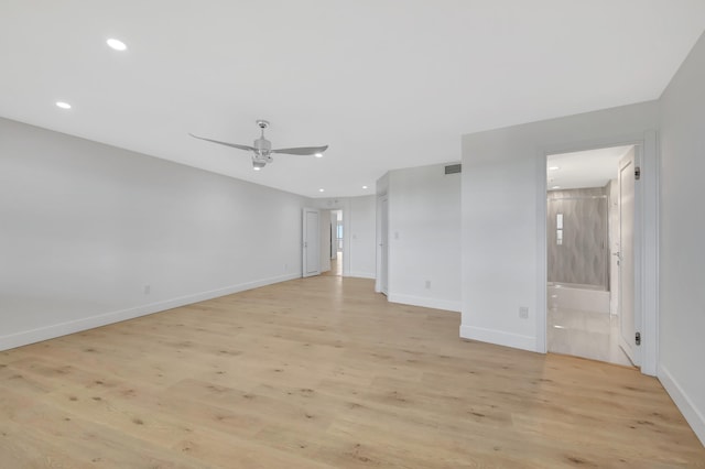 empty room with ceiling fan and light wood-type flooring