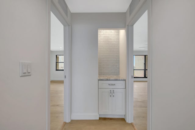 corridor with light hardwood / wood-style flooring