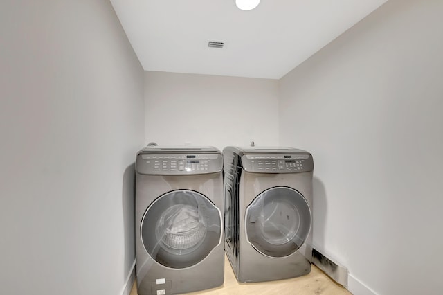 clothes washing area featuring separate washer and dryer