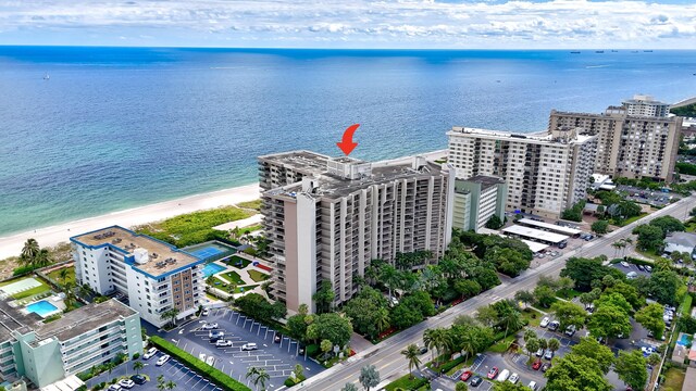 aerial view featuring a water view and a beach view