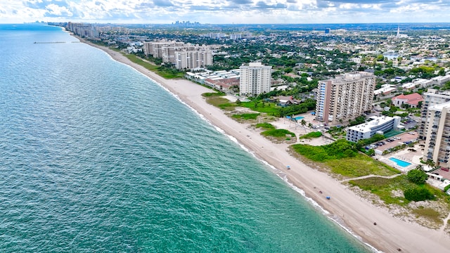 birds eye view of property with a beach view and a water view