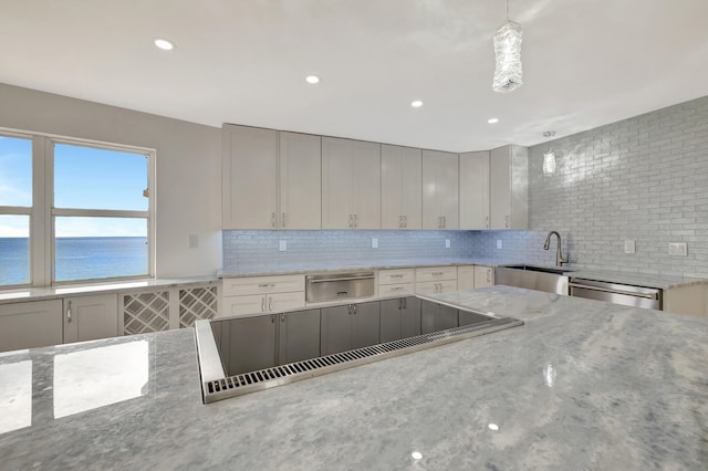 kitchen featuring gray cabinets, tasteful backsplash, sink, dishwasher, and light stone counters