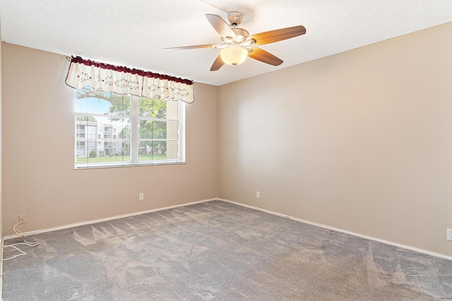 unfurnished room featuring carpet flooring, ceiling fan, and a textured ceiling