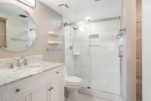 bathroom with vanity, an enclosed shower, and toilet