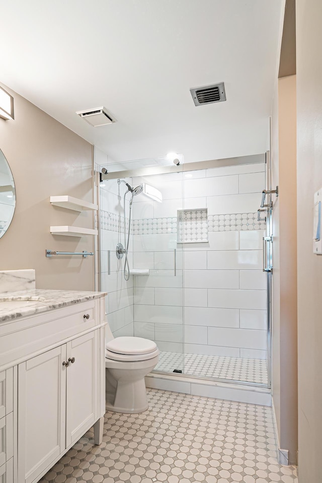 bathroom featuring vanity, toilet, and walk in shower