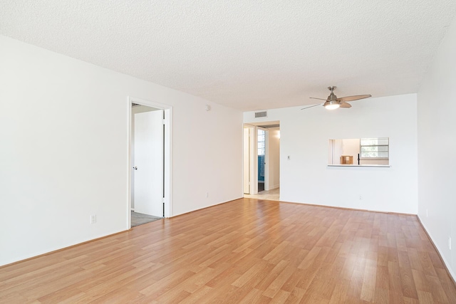 unfurnished room with ceiling fan, light hardwood / wood-style flooring, and a textured ceiling