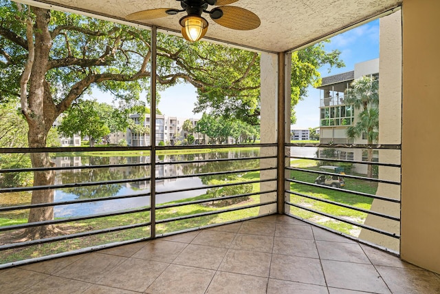 balcony featuring ceiling fan and a water view