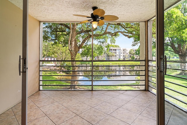 unfurnished sunroom featuring a water view