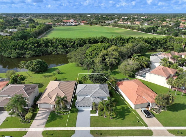 drone / aerial view featuring a residential view and a water view