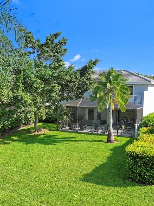 view of yard with a patio area and a balcony