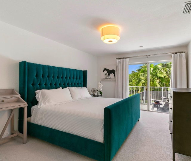 carpeted bedroom with access to outside and visible vents