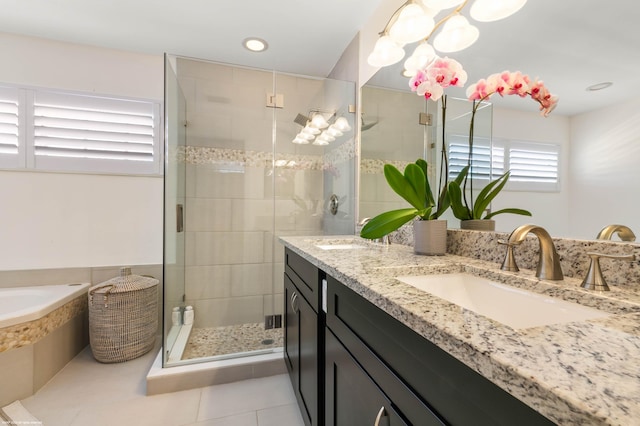 bathroom with tile patterned flooring, separate shower and tub, and vanity