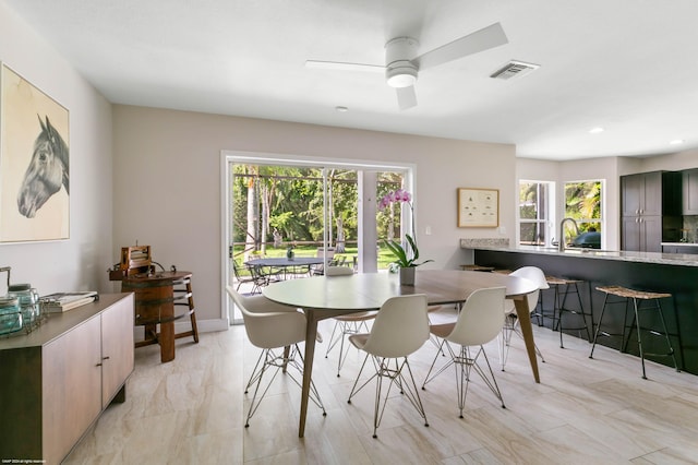 dining area featuring baseboards, visible vents, and a ceiling fan