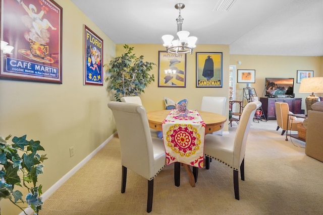 dining area featuring carpet flooring and an inviting chandelier