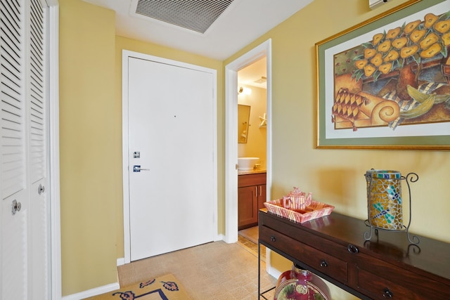 view of carpeted foyer entrance