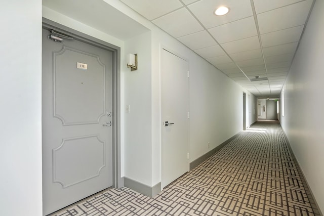 hallway featuring a paneled ceiling